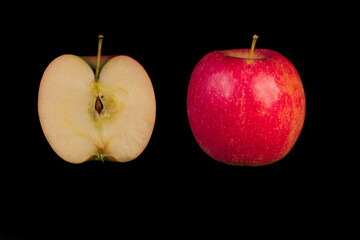 Whole and sliced ​​apple on black background
