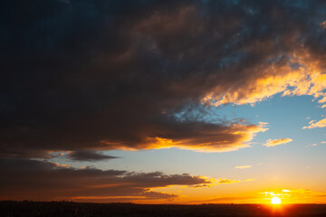 Fototapeta na wymiar Natural landscape of colourful sunset or sunrise with dark clouds.
