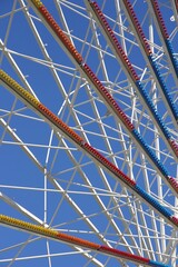 close-up view of ferris wheel brews on blue sky background, entertainment concept