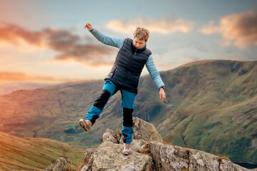 Woman reaching the destination and on the top of mountain against cloudy blue sky on autumn day Travel Lifestyle concept The national park Lake District in England