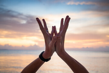 hand in lotus mudra at sunset