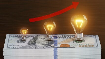 Lightbulbs on stack of money. Energy consumption, high prices and economy concept.