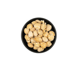 Candlenut in a small bowl isolated. kitchen spice design elements