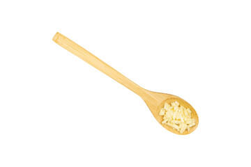 Garlic piece in a wooden spoon isolated