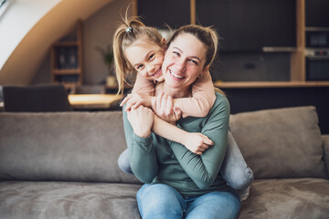 Obraz premium Happy mother and daughter enjoy spending time together at their home. 