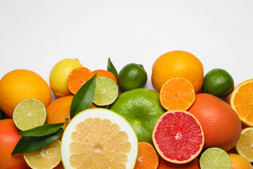 Different citrus fruits with fresh leaves on white background, top view. Space for text