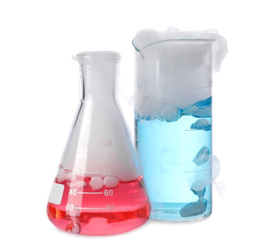 Laboratory Glassware With Colorful Liquids And Steam Isolated On White. Chemical Reaction