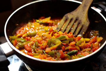 Close-up view of mix of colored vegetables cooking over pan. steaming mixed vegetables in the wok, asian style cooking vegetarian and healthy