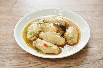 boiled chicken wing with Chinese herb stew on plate 