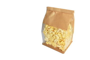 salty popcorn in brown paper packaging bag on white background