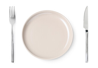 Empty beige plate with fork and knife on white background, top view