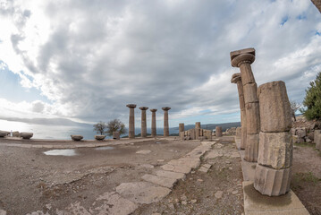 View of Assos Athena Temple ruins of Canakkale province with clouds on blue sky