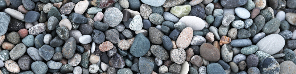 Fototapeta na wymiar Many different pebbles as background, top view. Banner design