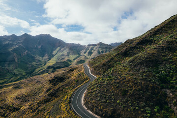 Drone view of savage road in the middle of colorful mountain landscape