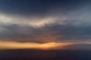 Naklejka na ściany i meble Abstract sunset over the sea with dramatic clouds