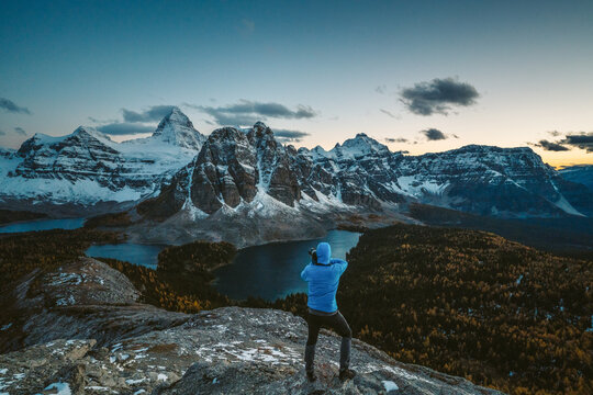 Photographer taking a picture of Mt. Assiniboine at dusk. 