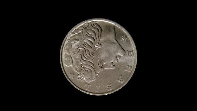 Obverse of old Brazil coin with portrait of a beautiful woman wearing the Phrygian cap, isolated in black background. 4k video