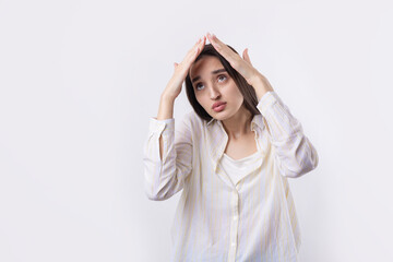 Portrait of a serious young woman showing stop gesture with her palm over white background