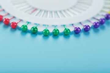 Sewing mother-of-pearl pins in a round white package