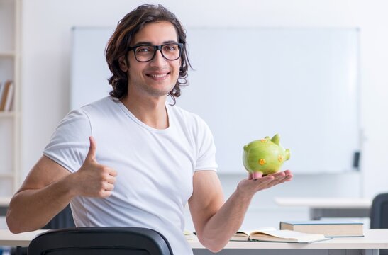 Young male student in front of whiteboard