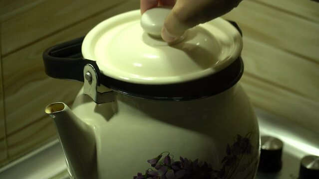 Kettle of classical form, boiling on a gas stove