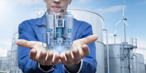 Development engineer holds in his hands a model of machine for the production of hydrogen by...
