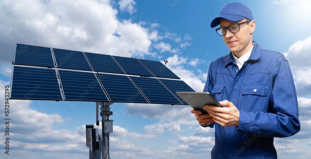 Poster engineer with tablet computer on a background of solar energy power station