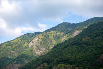 Fototapeta na wymiar Mountain landscape. Mountains with vegetation against the blue sky.