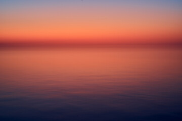 Abstract sunset over the sea with blue hour clouds