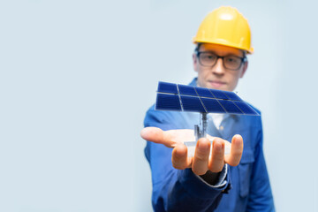Development engineer holds in his hand a model of a solar panel created in augmented reality.