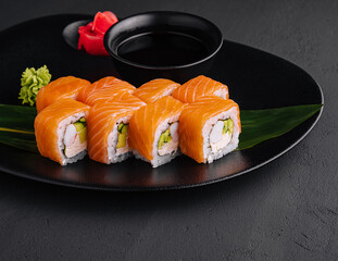 Delicious philadelphia sushi on black plate