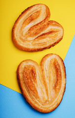 Puff pastry cookies on blue and yellow background