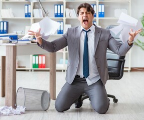 Angry businessman shocked working in the office fired sacked