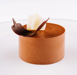 Plate with coffee panna cotta on white