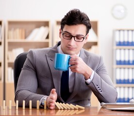 Businessman with dominoes in the office