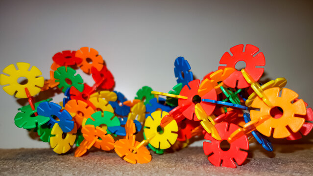 Colorful stick flowers arranged in an elaborate architecturally impressive top construction . Children's toys for creative thinking , imagination and working . Flower power fun patch toys. Steckblumen