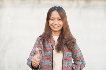 Asian woman raising hand showing great sign