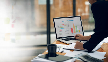 Professional businesswoman using laptop analysis business growth graph financial and marketing at...