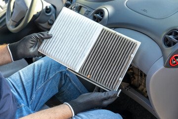 Naklejka na ściany i meble Replacing cabin pollen air filter for a car