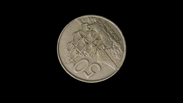 Reverse of New Zealand coin 50 cents with image of Endeavour ship, isolated in white background. Close up view.