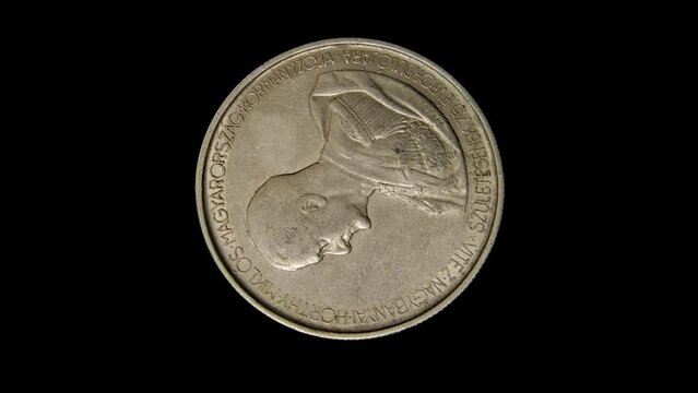 Obverse of Hungary commemorative coin 5 pengo 1943 with inscription meaning GOVERNOR OF HUNGARY MIKL&Oacute;S HORTHY ON HIS 75TH BIRTH ANNIVERSARY, isolated in black background. Close up view.