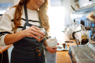 Female barista making coffee in a coffee machine. Food and drink concept. - obrazy, fototapety, plakaty