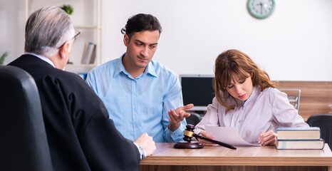 Young couple in the courthouse in divorce concept