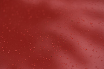 Raindrops on car paint surface after protection treatment