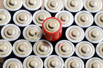 many round batteries and one red battery