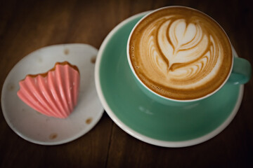 Top view of cappuccino and heart shaped cake