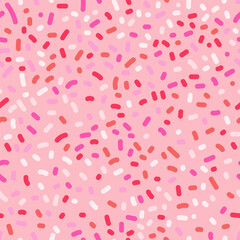 Seamless pattern with pink and white sprinkles on pink background.