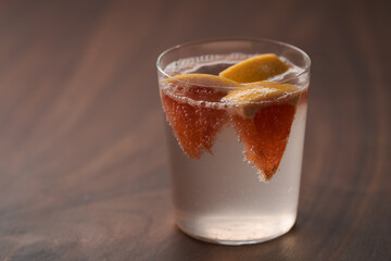 Grapefruit lemonade in tumbler glass on wood table