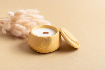 Interior candle in a plaster candlestick. Candle is decorated with potal. Scented candle and dried flowers
