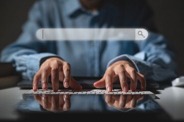 Hands of business woman typing on keyboard with search icon for web design template.